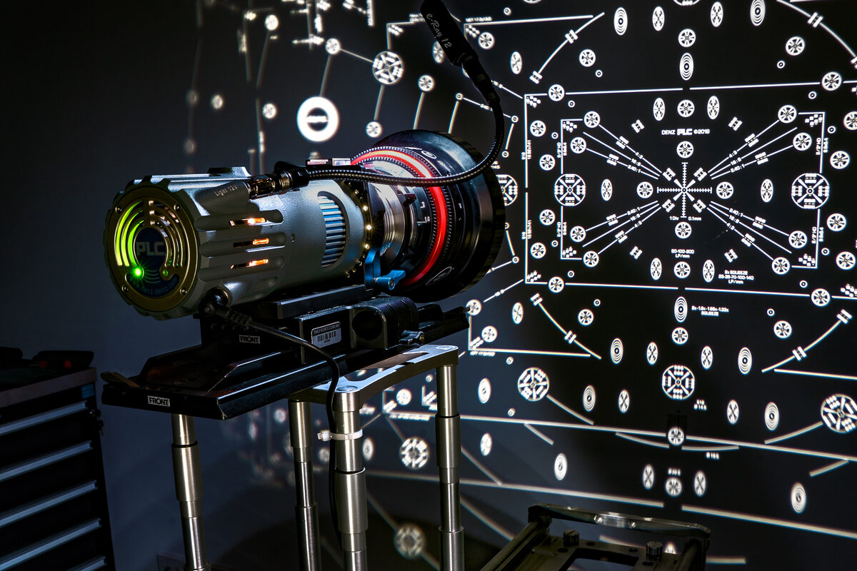 The lens projector and collimator set up against the projected test chart